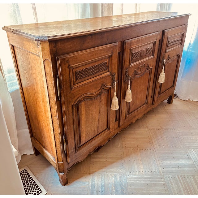 Rare hand-carved basket weave motif with perforation, paneled doors, three interior cutlery drawers lined with grey felt,...