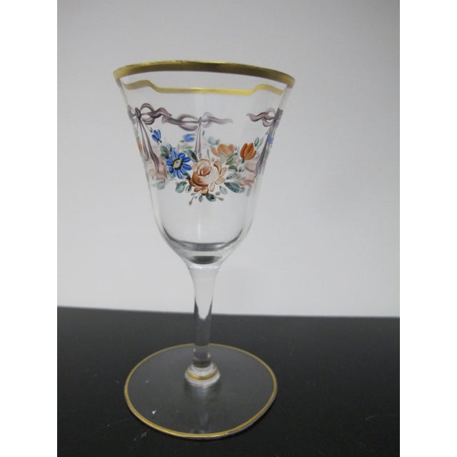 Very sweet vintage cordial or aperitif glass. Clear glass with hand painted colorful floral and bow design. Rim has gold...