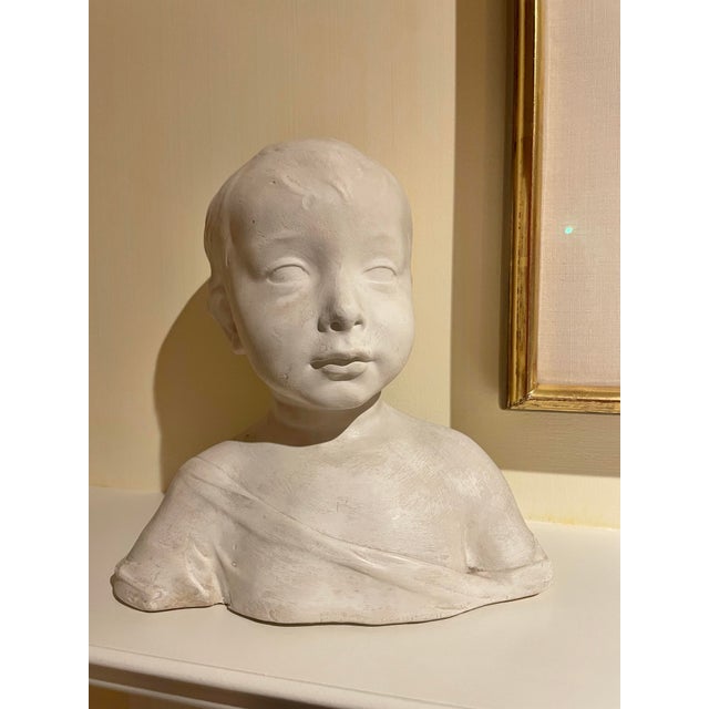 This sweet bust of a little boy is done in plaster and has delicate features. It’s the portrait of a boy probably 6 or 7...