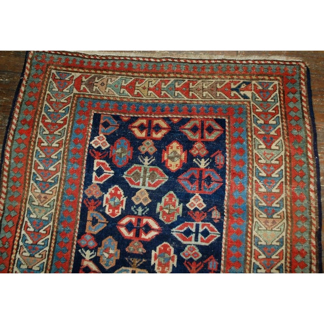 Antique handmade Caucasian Gendje rug in good condition. The rug has dark blue field covered in tribal figures, made in...