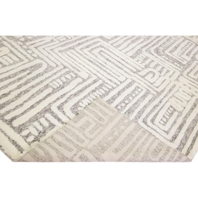 Beautiful modern Moroccan style hand-knotted wool rug with a light gray color field and ivory accents in a gorgeous...