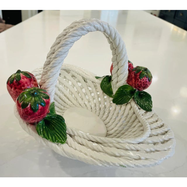 This charming handcrafted ceramic basket appears to be a fine example of Italian ceramic artistry, possibly from Lanzarin...