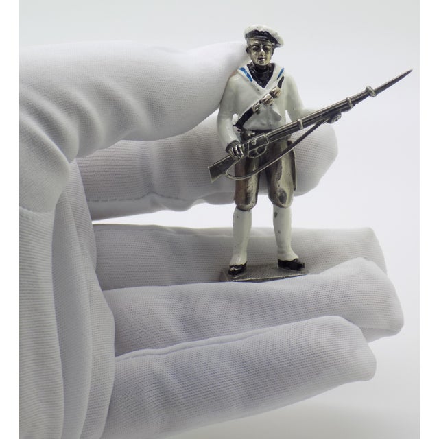 This Italian silver miniature captures a detailed historical figure of a Royal Italian Navy sailor outfitted in the combat...