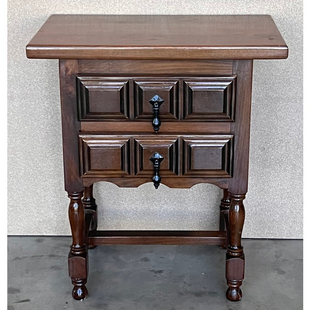 20th century pair of Spanish nightstands with two carved drawer and iron hardware and crest in the low part of the...