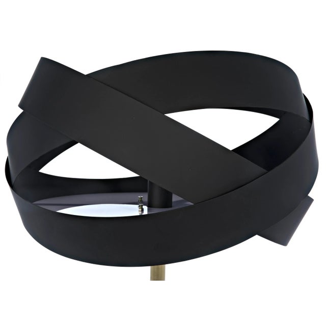 Anchored by a cylinder of white stone, the Orion floor lamp is topped with a satellite inspired sculpture in black metal...