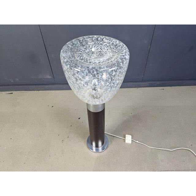 Vintage floor lamp by Mazzega with a chromed and brown metal base with in integrated lamp in the base and a murano glass...
