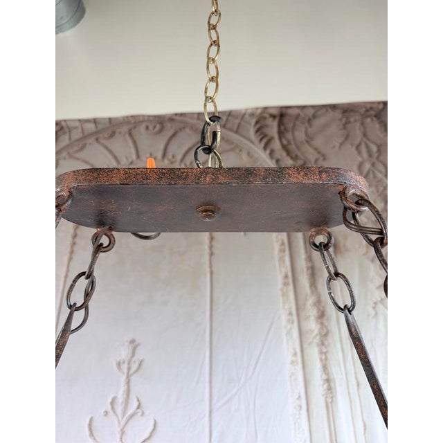 Monumental Spanish style wrought iron chandelier, circa 1950-1970. Hand-forged iron in a geometric octagonal form with 6...