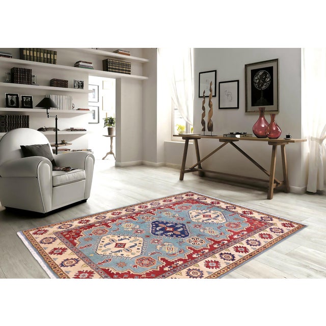 Enhance your home with this exquisite hand-knotted Kazak rug, crafted from fine hand-spun wool and dyed with all-natural...