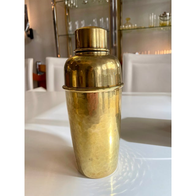 A very unusual and rare cocktail shaker in solid brass with hammered decoration.