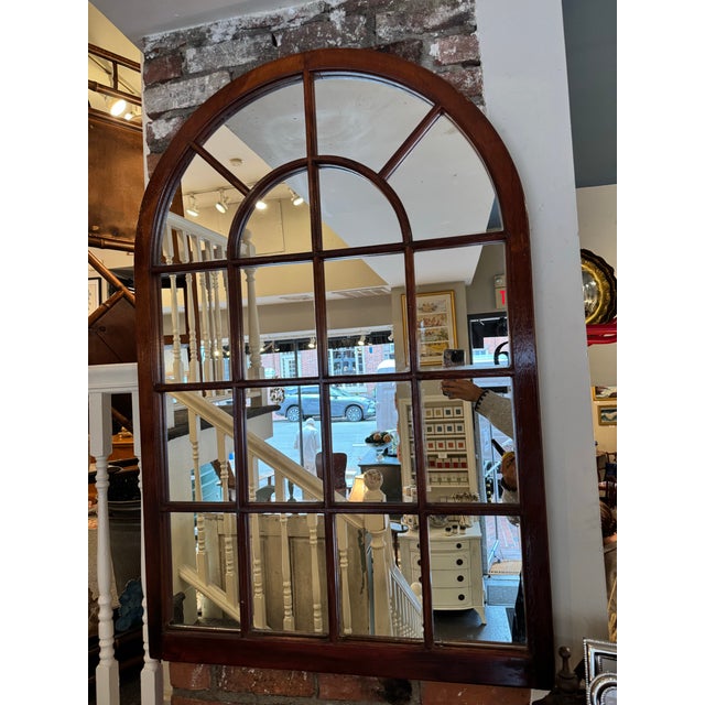 This is an antique window frame mirror. It is made of mahogany wood and mirror. It is very chic and can complement any...