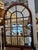 This is an antique window frame mirror. It is made of mahogany wood and mirror. It is very chic and can complement any...