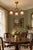 A romantic early 20th-century three-light semi-flush chandelier featuring an ornate brass frame and three matching pink...