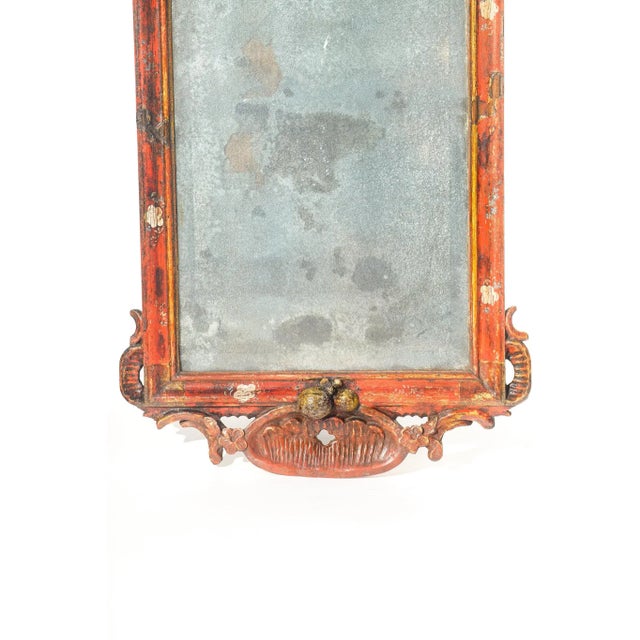 19th c. finely carved small red painted mirror with fruit motif. 32"H 14.5"W