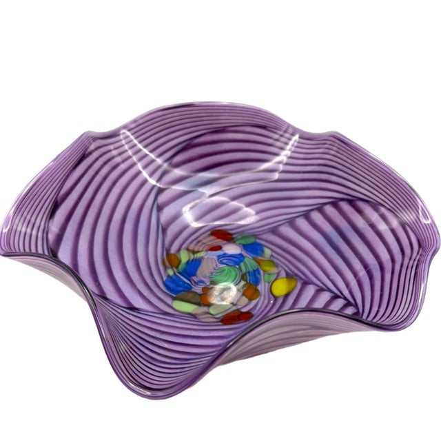 This decorative bowl exemplifies the traditional Venetian glassmaking technique known as 'mezza filigrana,' where colored...