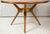 Italian Mid-Century Modern mahogany circular dining table/center table with central bronze ring on tripod base.