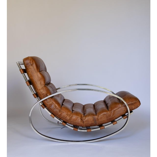 Renato zevi brown leather rocking chairs produced by selig, italy, circa 1970. polished chrome frame with rockers and arms...