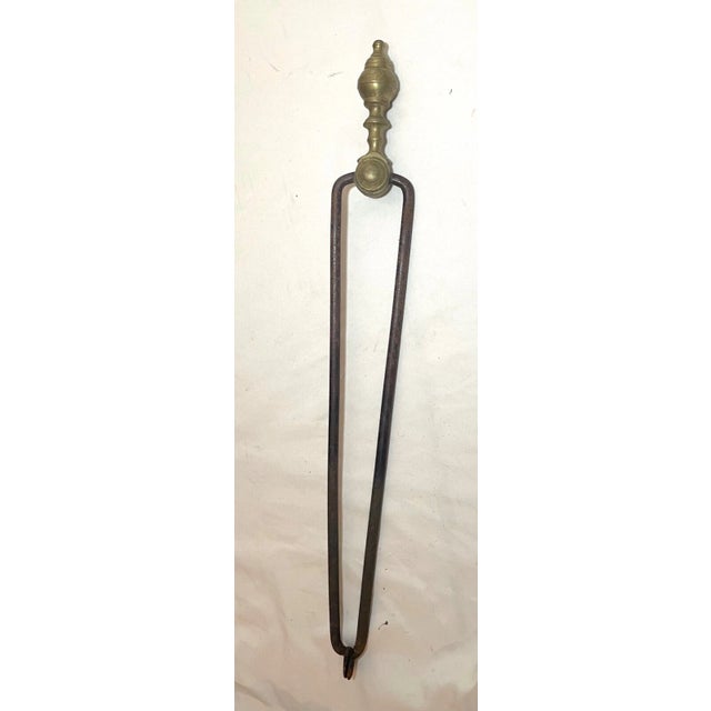 Up for sale is a pair of rare antique 18th century wrought iron and brass English fireplace tongs. The arms are wrought by...
