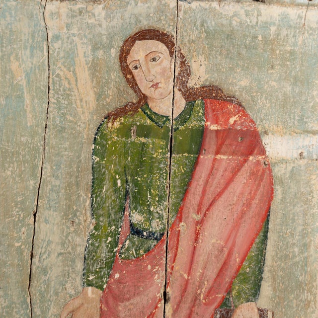 Original oil painting executed on wood planks depicting St. John the Evangelist, likely once part of a larger Calvary...