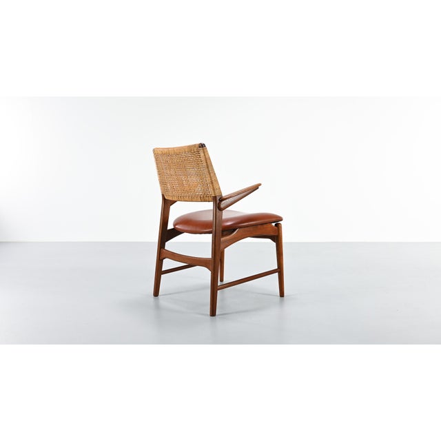 The Model 48 armchair, designed by E. Knudsen and produced by cabinetmakers Jensen & Lykkegaard in Odense, is a fine...