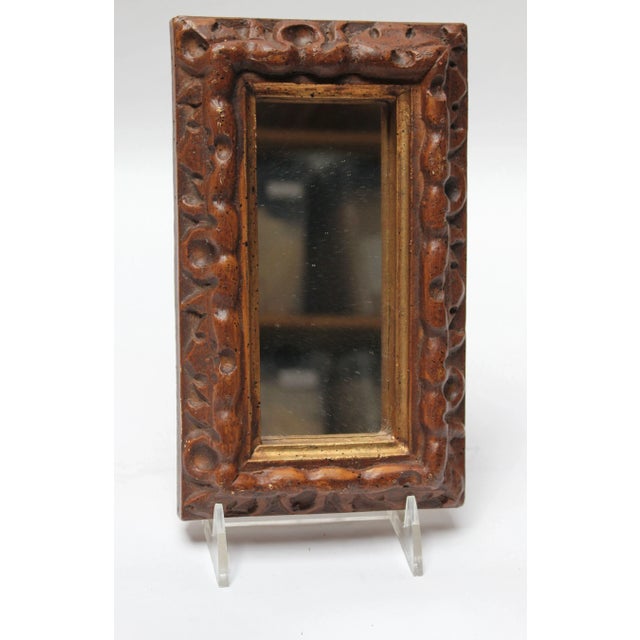 Ca. 1970s Mexican made mirror composed of inset glass within a deep, faux-wood, molded-resin frame lined with gilt paint....