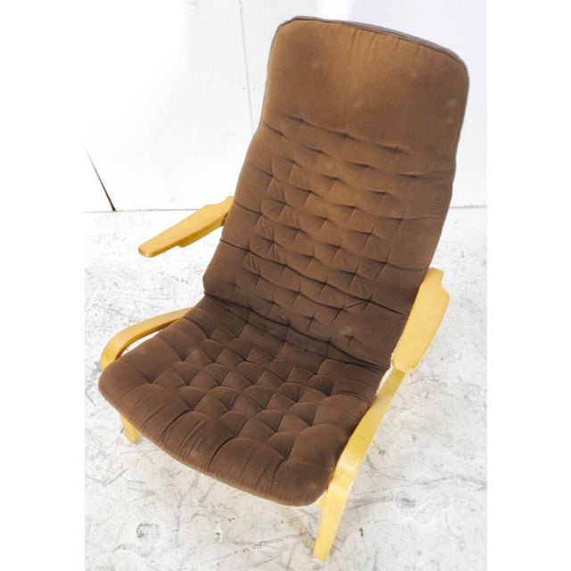 We are featuring a Danish Modern lounge chair by Dux. This chair features a button tufted, brown upholstered seat cover...
