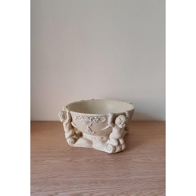 Large bowl decorated with angels. 20th century Richly decorated with festoons and putti. (angels) A few chips but no major...