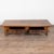 19th-century French oak coffee table featuring a deep, richly aged patina resting on four turned legs. The simple form...