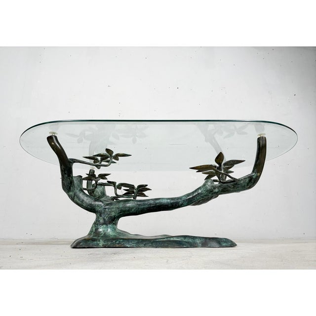 Willy daro, coffee table, 'bonsai', 1970s, solid brass construction, with an oval glass top, dimensions approx.: h. 42.5...