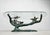 Willy daro, coffee table, 'bonsai', 1970s, solid brass construction, with an oval glass top, dimensions approx.: h. 42.5...