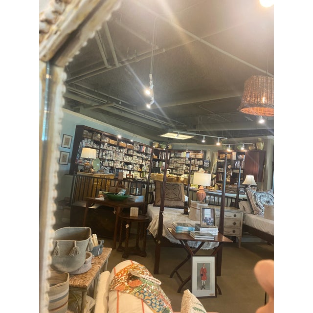 Oversize antique frame mirror in a distressed white finish. The chunky arch top frame with carved detail features five...