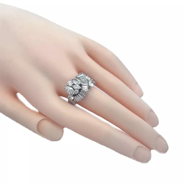 This is a stunning platinum cocktail ring, the tapered band has baguette which continued from the back to the front in a...