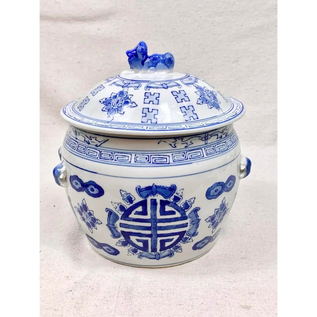 This vintage Chinese export porcelain jar is decorated in classic cobalt blue over a crisp white glaze. The central body...