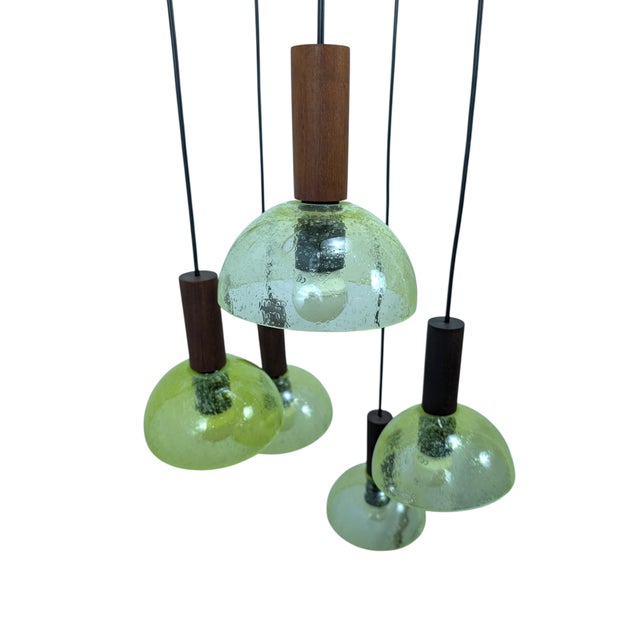This stunning cluster pendant lamp is a true example of midcentury modern design dating back to the 1960s, characterized...