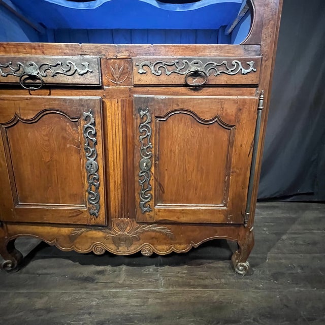 A beautiful 19th century French Provincial display cabinet, handcrafted in richly figured walnut with elegant hand-carved...