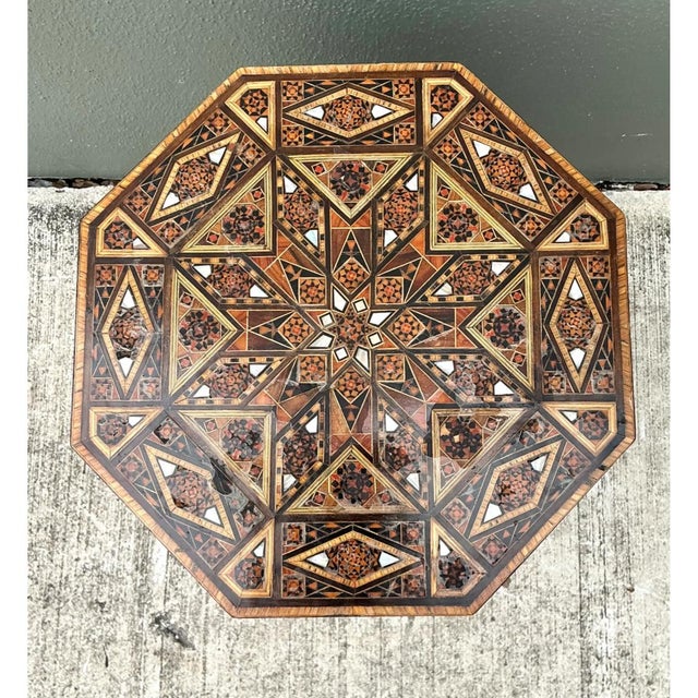 This octagonal side table is a showcase of fine marquetry, its tabletop and tapering body entirely covered in intricate...