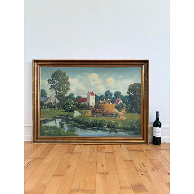This large original vintage oil painting, from around 1970, shows a peaceful countryside village with cottages, a church...