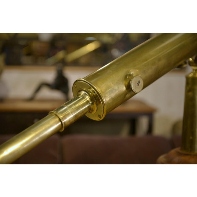 Beautiful antique brass telescope, mounted on a wooden tripod with brass hardware and adjustments. The long shaft and the...