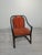 This armchair is made of rattan and features distinctive vintage armrests. The seat and backrest are upholstered in soft,...