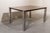 Italian extendable dining table from the 1970s. It features a rectangular frame with clean lines and proportions. It...