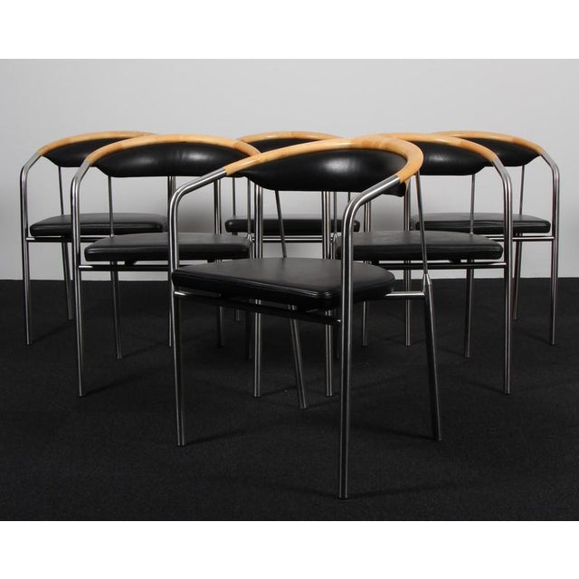 Henrik Tengler armchairs in steel and backrest of maple. Upholstered with black leather. Made by Hansen & Sørensen. This...