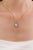 This Art Deco Inspired halo pendant showcase 1.43 carat natural oval turquoise, set in 14K yellow gold. The center stone...