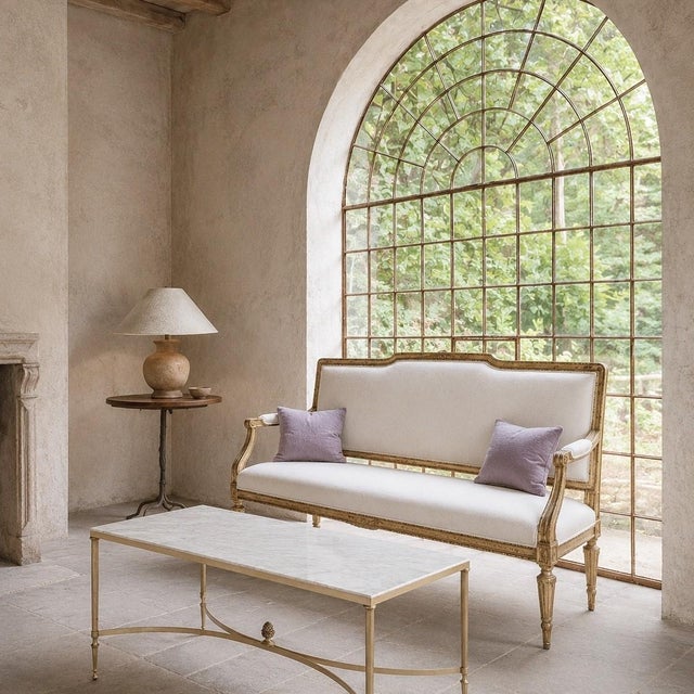 A refined mid-century coffee table in the Maison Jansen style, combining a beautifully veined Carrara marble top with a...