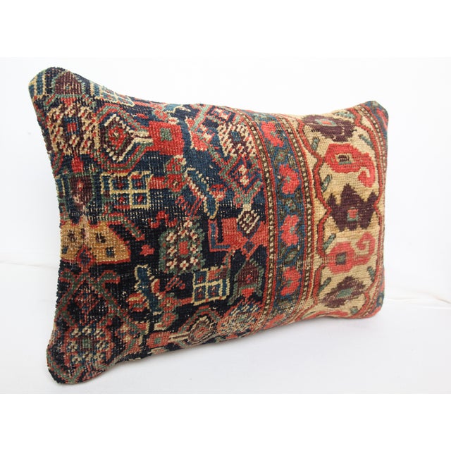 This one of a kind pillow cover is crafted from a genuine antique tribal rug, showcasing centuries old weaving traditions....