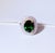 An exceptional 18K white and yellow gold halo ring featuring a GIA-certified natural Zambian oval emerald weighing 3.65...