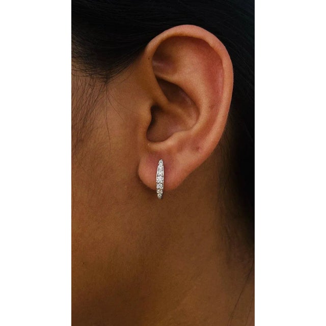 This is part of Chairish’s Fine Jewelry assortment. Dainty Diamond Huggie Earrings in 18K Gold to make a statement with...