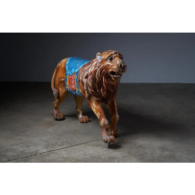 Behold this majestic antique carousel figure featuring a regal lion. Meticulously hand-carved from wood, this vintage...