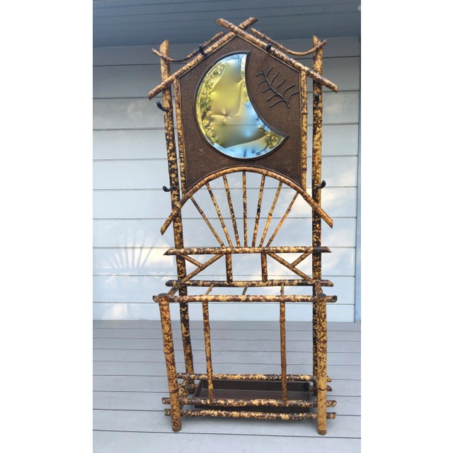 Olde English Tortoise Shell Bamboo Hall Tree, mid-late 19th century. Beveled crescent form mirror set in a tightly woven...