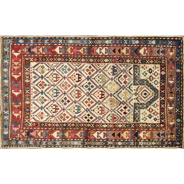 Antique Shirvan Prayer rug with multi-color motives on white background field. The historic Khanate or administrative...