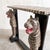 A distinctive vintage wooden console table with hand-painted tiger stripes and sculptural tiger figures forming the...