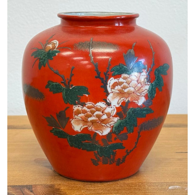 Vintage Kutani style Japanese porcelain vase with vibrant red body and hand-painted intricate floral and bird motif. Age...